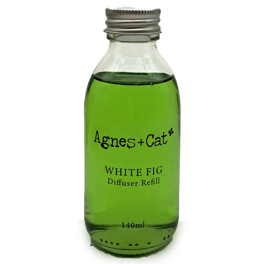 Green bottle of Agnes + Cat White Fig diffuser refill on a white background