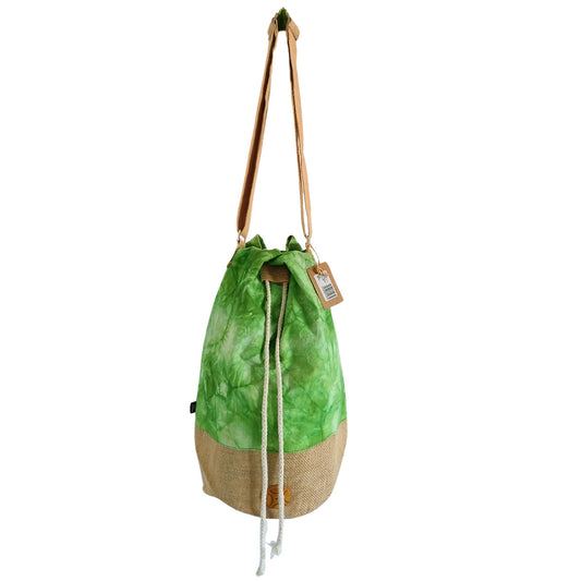 Green drawstring bag with beige base on a white background