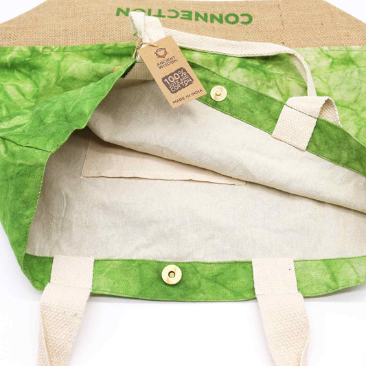 Green and beige fabric with a tag indicating 100% organic cotton on a white background
