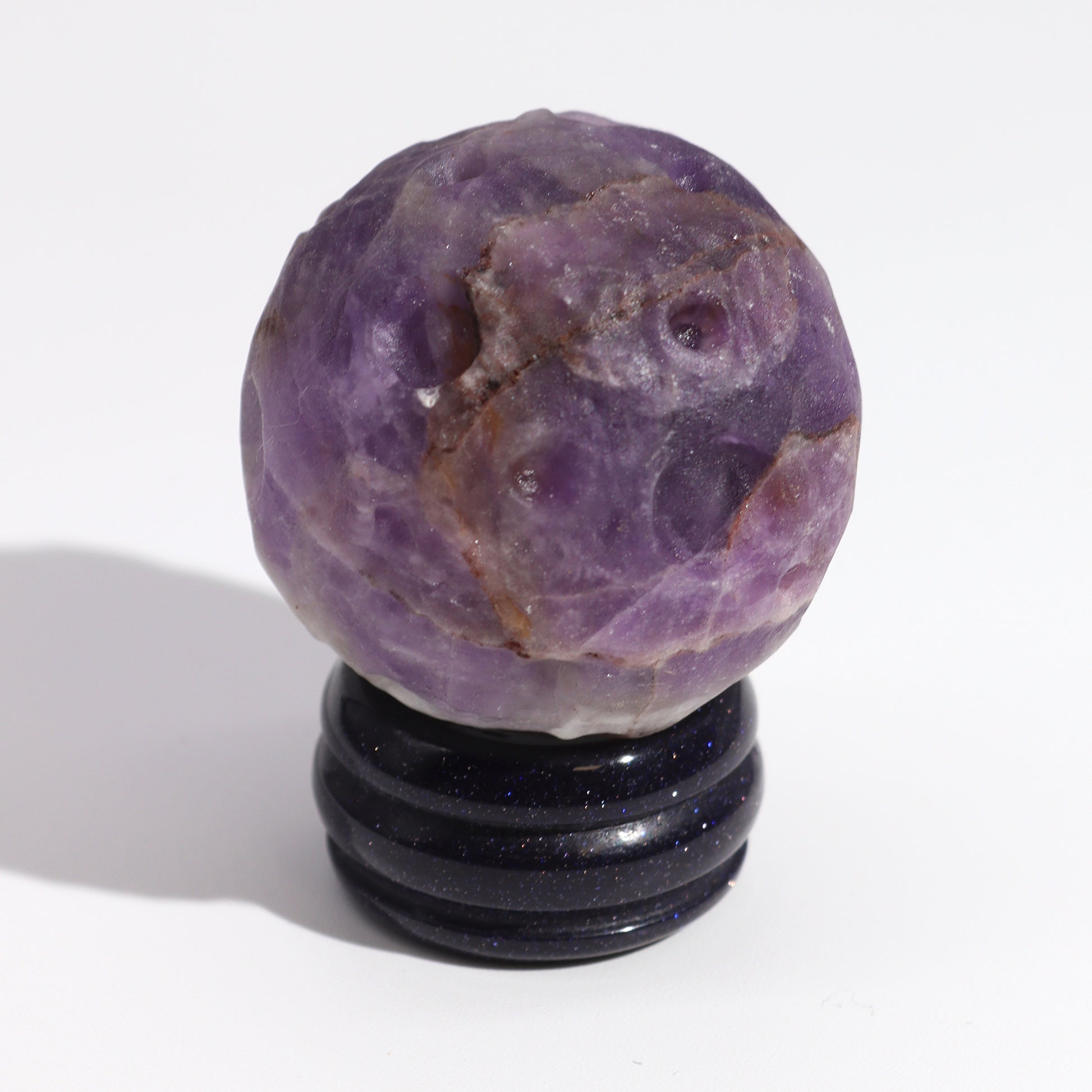 Invite the powerful energy of Jupiter into your space with this stunning Amethyst Planet. Expertly carved from genuine amethyst, a stone known for its connection to the crown chakra and spiritual growth