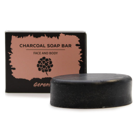 Charcoal soap bar with packaging on a white background
