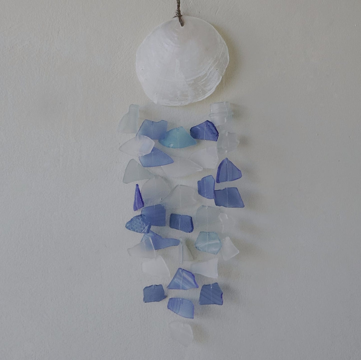 Bring harmony and a touch of nature to your outdoor space with a Recycled Glass Wind Chime Blue & White Glass.