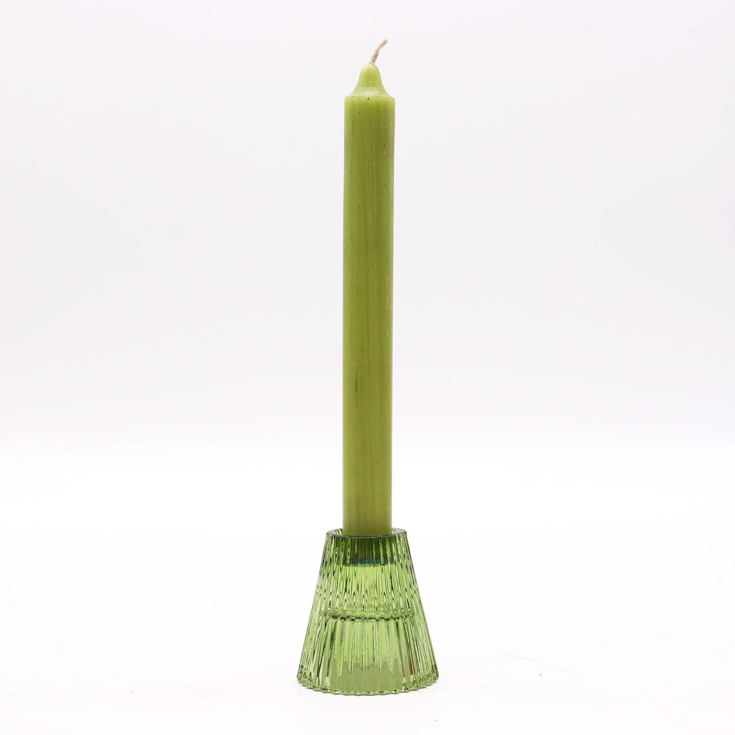 Green candle in a decorative holder on a white background