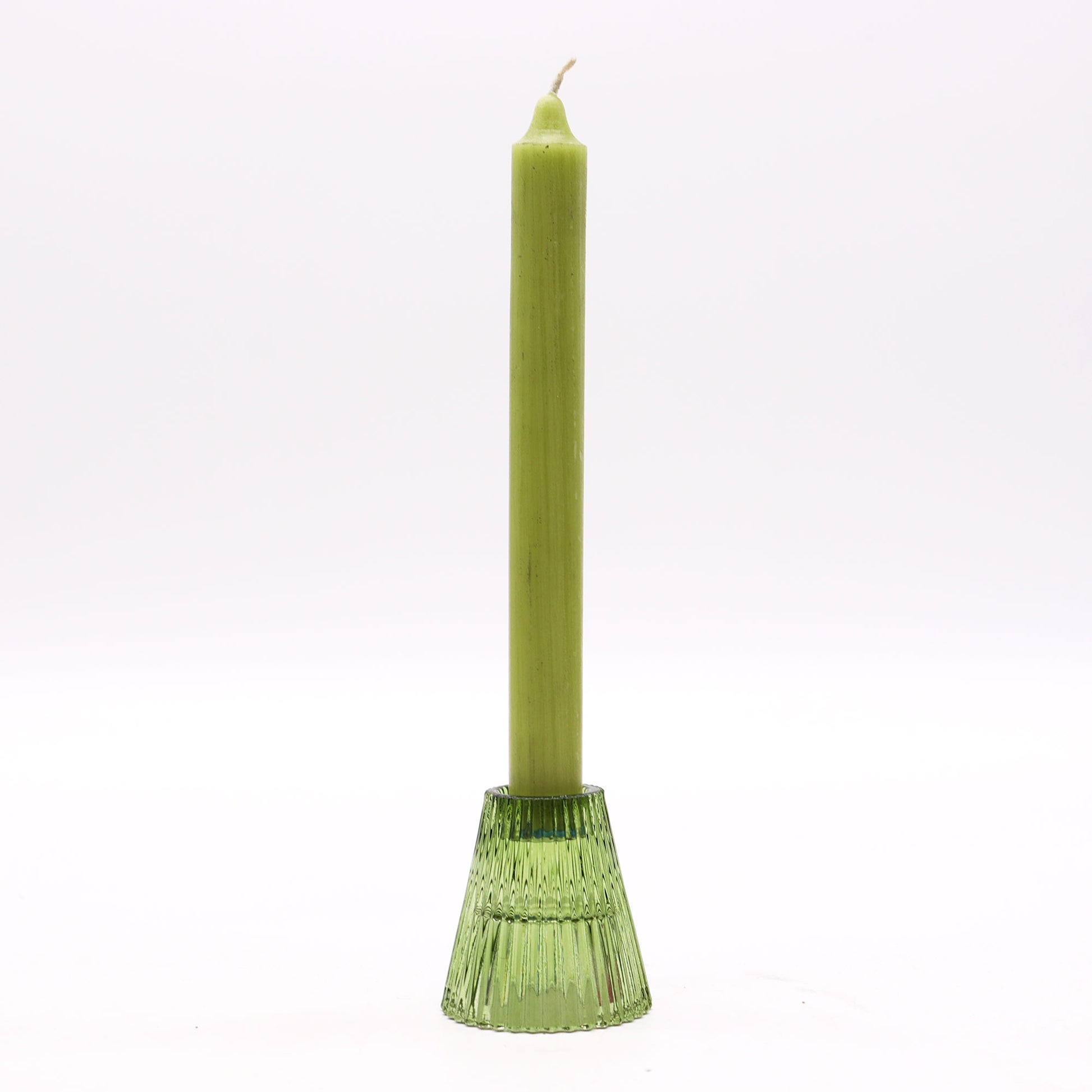 Green candle in a decorative holder on a white background