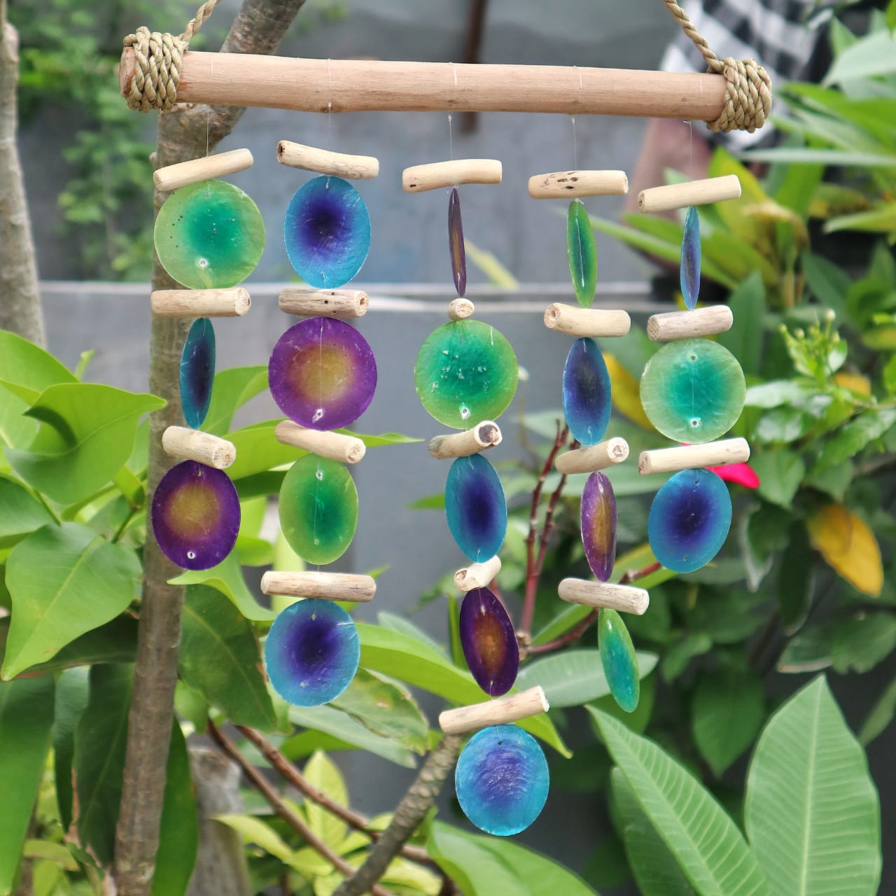 Bring a touch of natural elegance to your space with this handcrafted Green and Purple Driftwood Chime