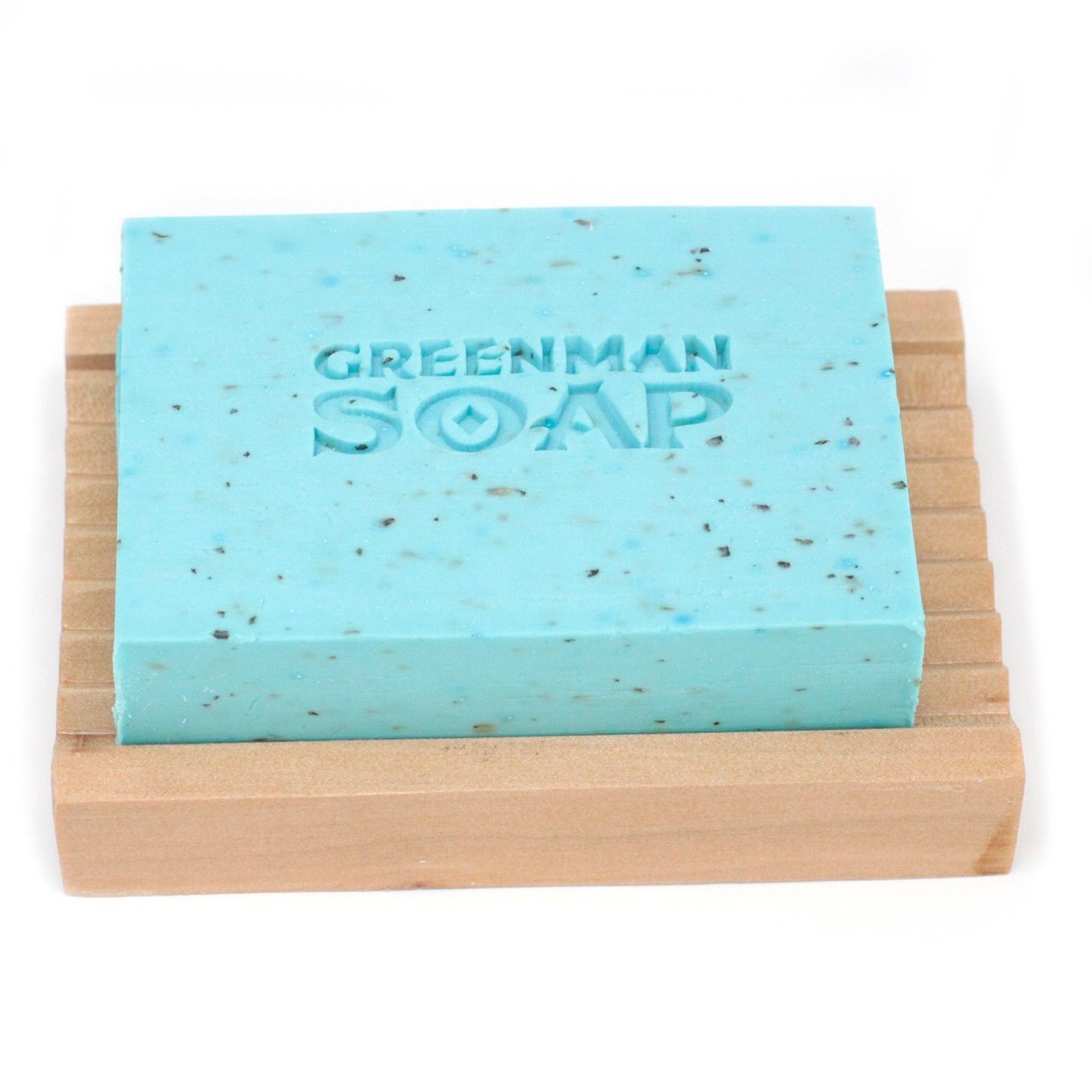 Greenman Soap bar on a wooden soap dish with a white background