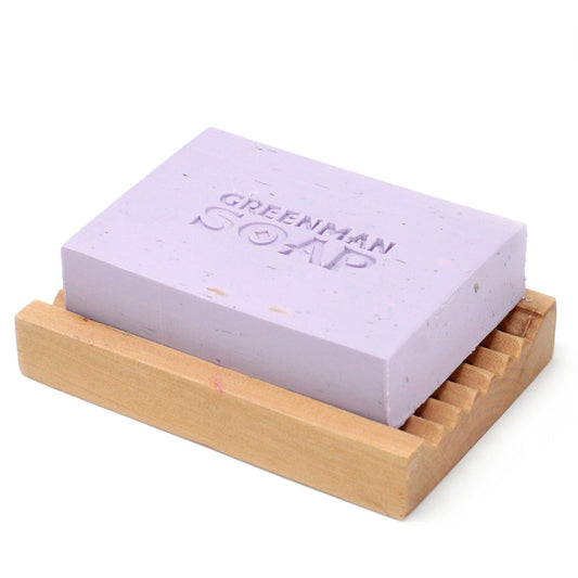 Purple bar of soap on a wooden soap dish with 'Greenman Soap' branding.