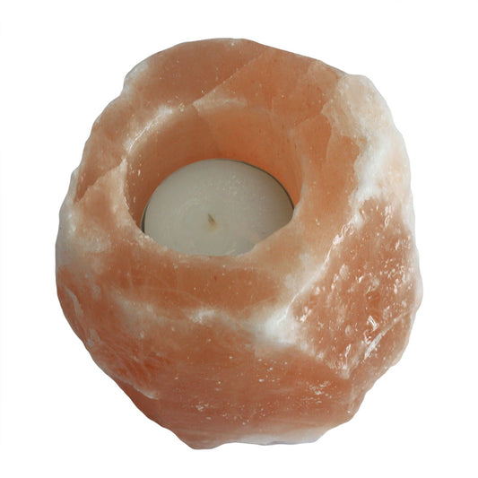 Himalayan salt lamp with a candle inside on a white background