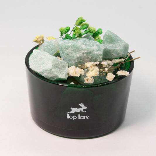 Black container with green crystals and flowers on a white background, featuring the 'Hooplaire' brand.