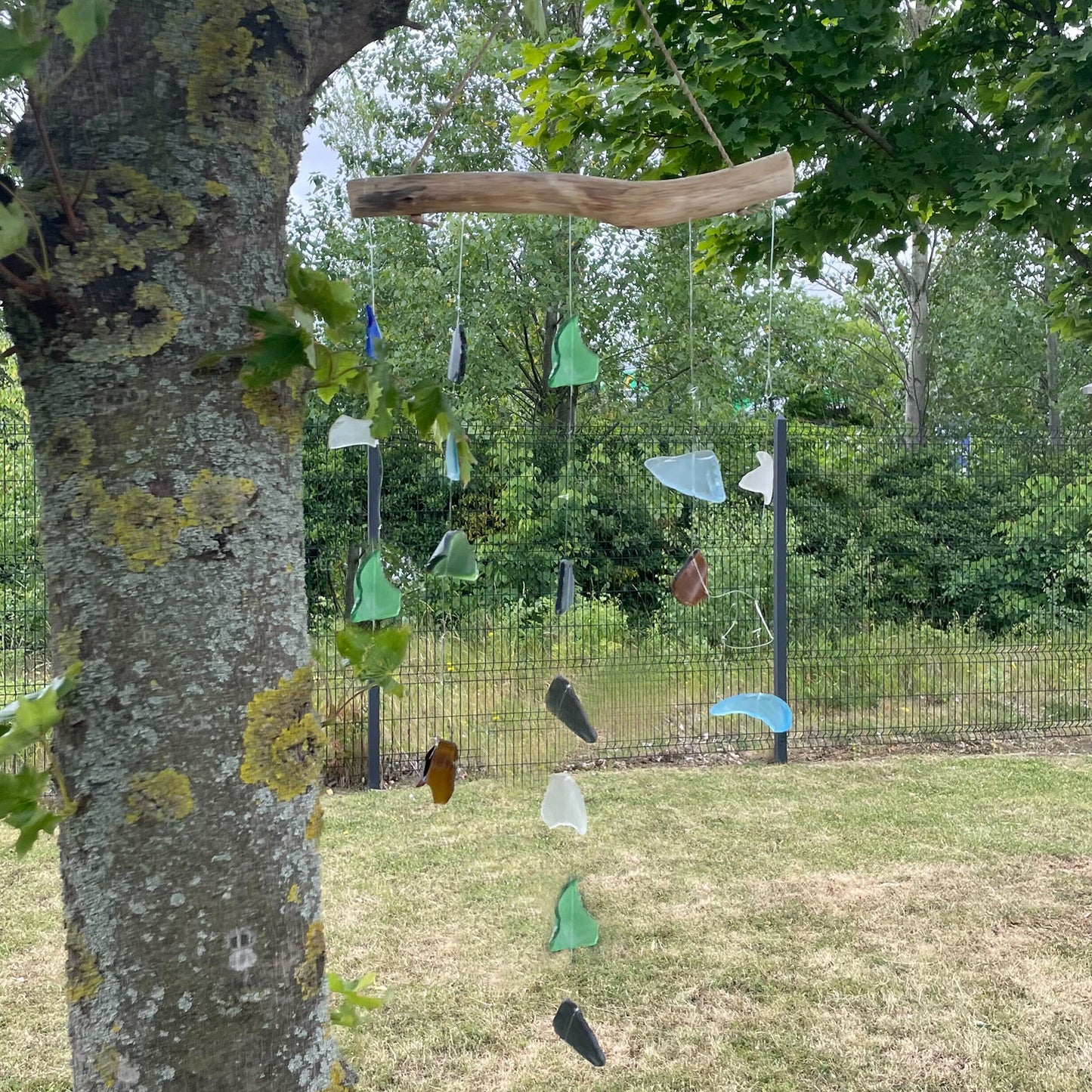 Bring harmony and a touch of nature to your outdoor space with a Recycled Glass Wind Chime Simple Hanging Five Strings.