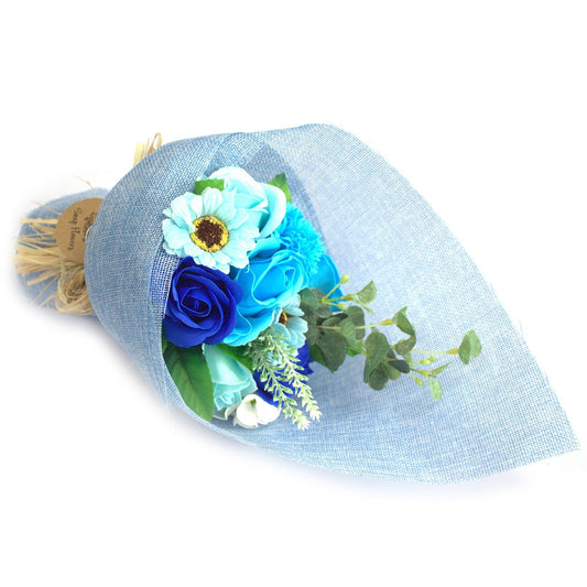 Bouquet of blue flowers wrapped in light blue paper on a white background