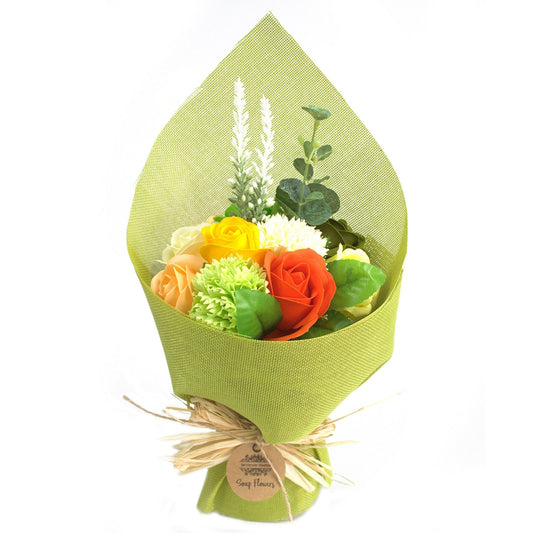 Bouquet of soap flowers wrapped in green paper on a white background