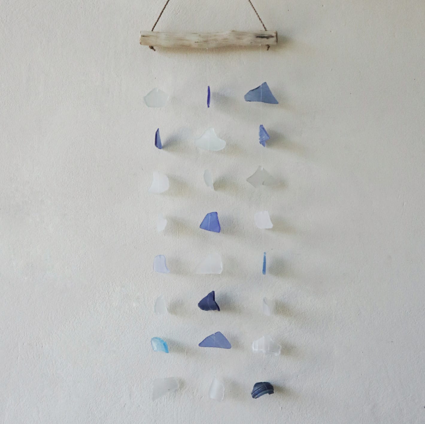 Bring harmony and a touch of nature to your outdoor space with a Recycled Glass Wind Chime Three Drop Blue & White.
