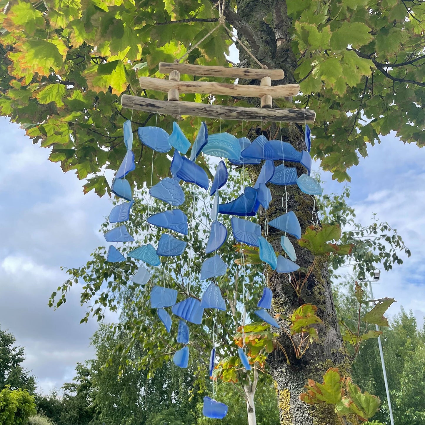 Bring harmony and a touch of nature to your outdoor space with a Recycled Glass Wind Chime Three Stick All Blues.