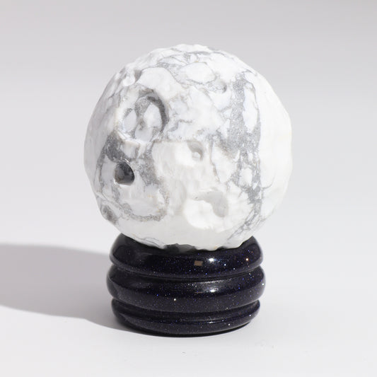 Embrace the calming and reflective energy of the Moon with this elegant White Howlite Planet.