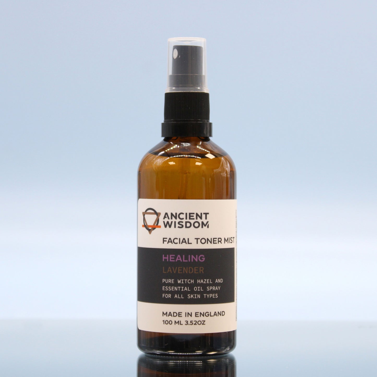 Bottle of Ancient Wisdom facial toner mist on a light blue background