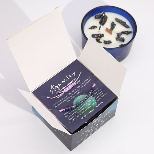 Zodiac Crystal Candle Aquarius with Gemstone Bracelet boxed is beautifully presented in a midnight blue glass jar adorned with silver-embossed star sign constellations.