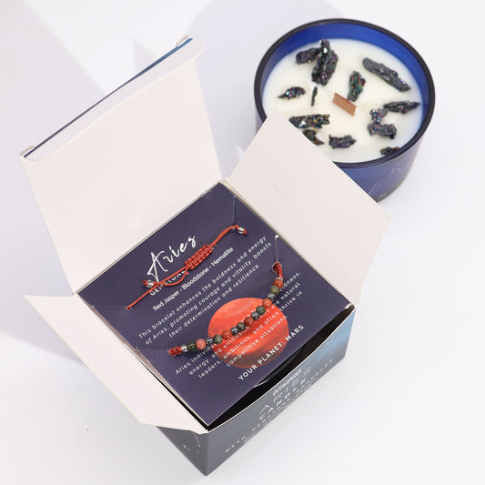 Zodiac Crystal Candle Aries with Gemstone Bracelet boxed is beautifully presented in a midnight blue glass jar adorned with silver-embossed star sign constellations.