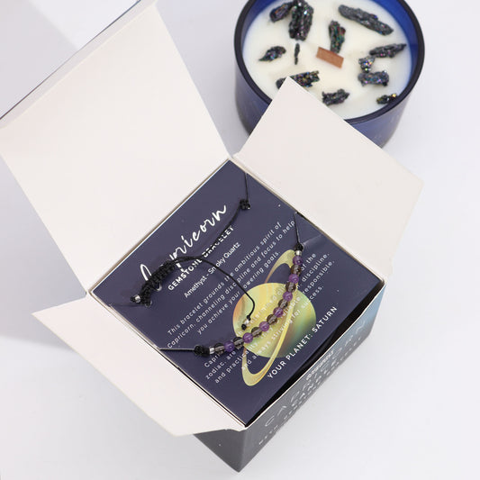 Zodiac Crystal Candle Capricorn with Gemstone Bracelet boxed is beautifully presented in a midnight blue glass jar adorned with silver-embossed star sign constellations.