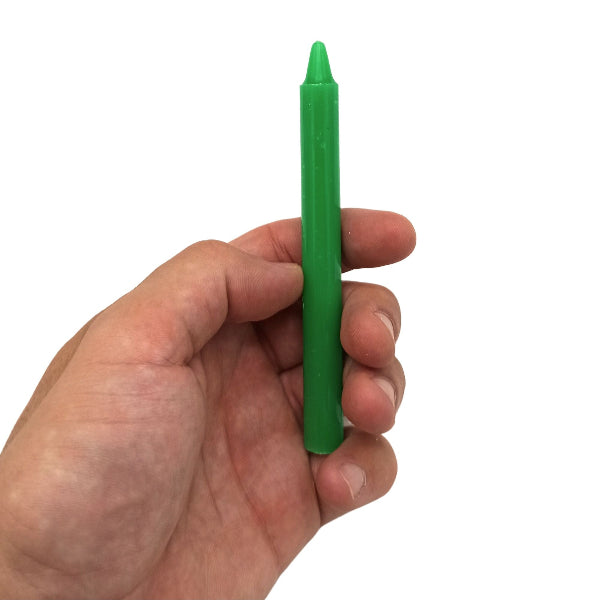 Hand holding a green crayon against a white background