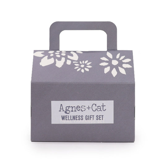 Gray gift box with floral patterns and 'Agnes + Cat Wellness Gift Set' label on a white background