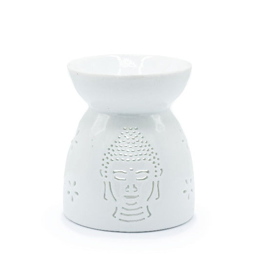 White ceramic oil burner with Buddha face design on a white background