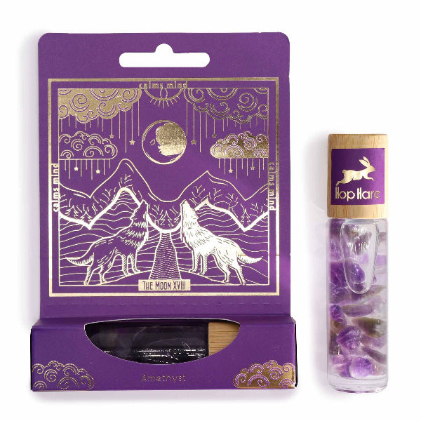 Purple packaging with gold accents featuring a wolf design, next to a clear tube with purple crystals and a rabbit illustration.