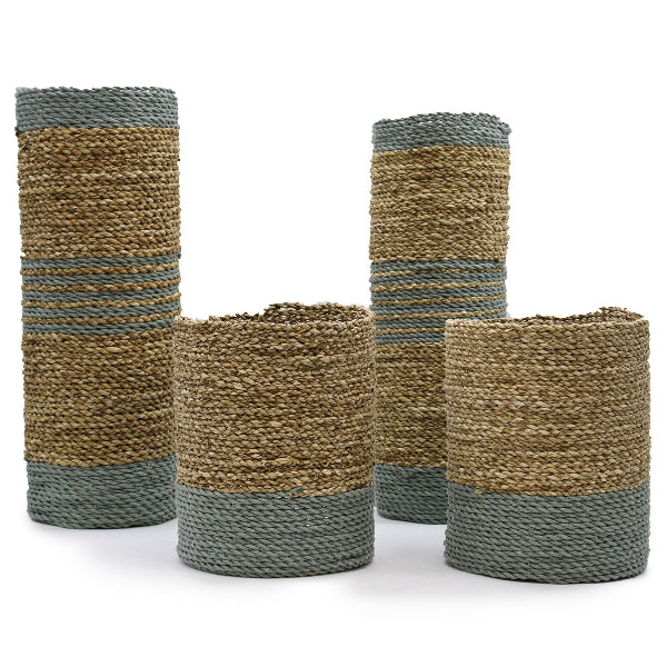 Set of four woven cylindrical baskets with striped pattern on a white background