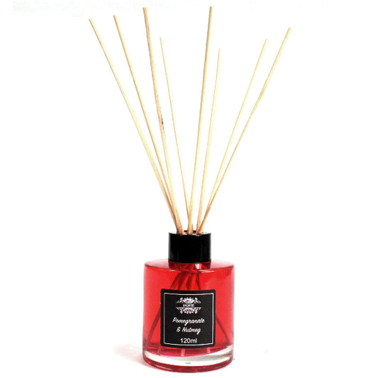 Red diffuser bottle with wooden sticks on a white background