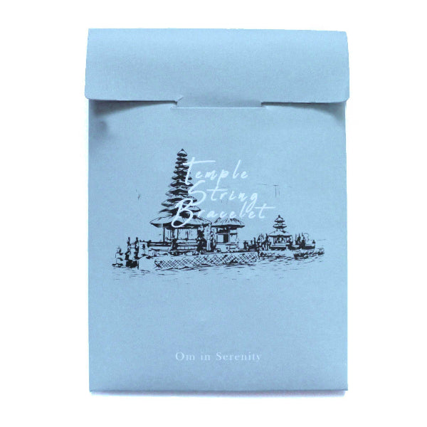 Light blue package with temple design and text on a white background