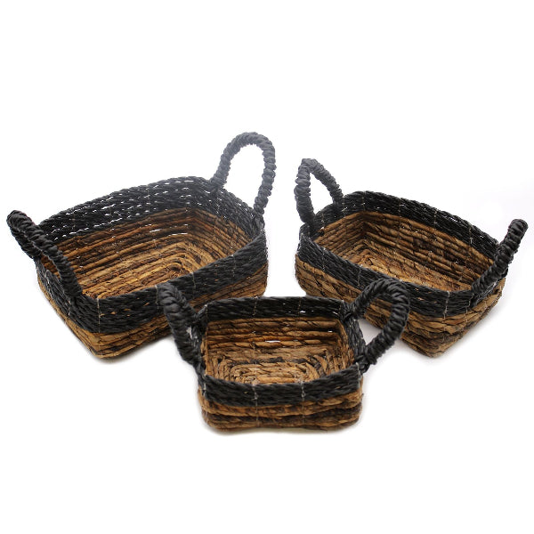 Three woven baskets with handles on a white background