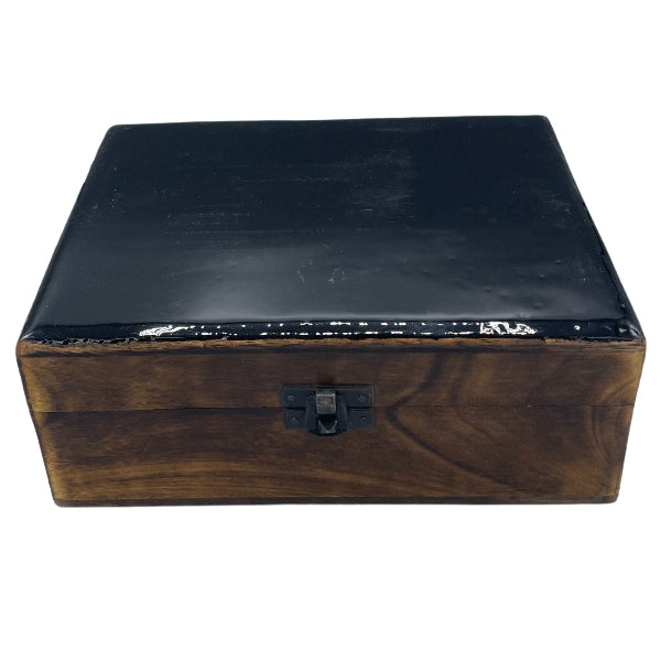 Wooden box with a black lid on a white background