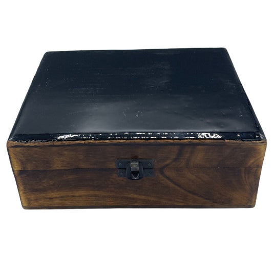 Wooden box with a black lid on a white background