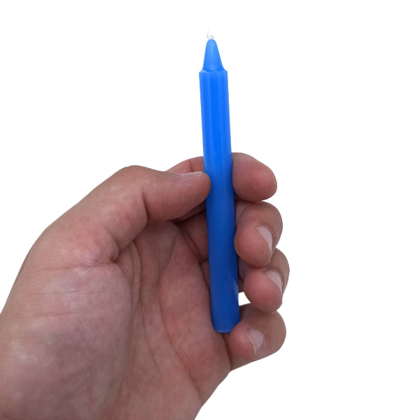 Hand holding a blue marker against a white background