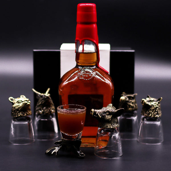 Bottle of Johnnie Walker Red Label whisky with a glass and decorative animal-shaped holders on a dark background