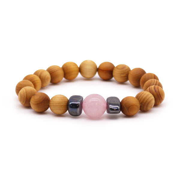 Wooden beaded bracelet with a pink stone on a white background