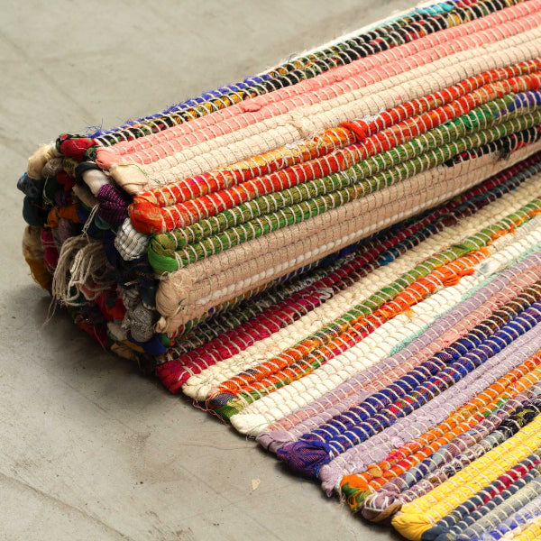 Multicolored striped rug on a light wooden floor