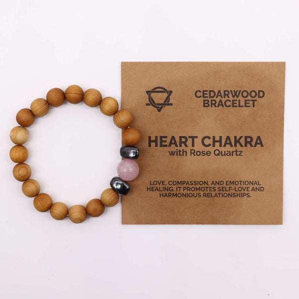 Wooden beaded bracelet with heart chakra stones on a brown card with text