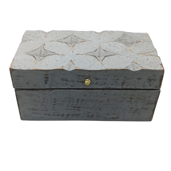 Decorative wooden box with star patterns on a white background