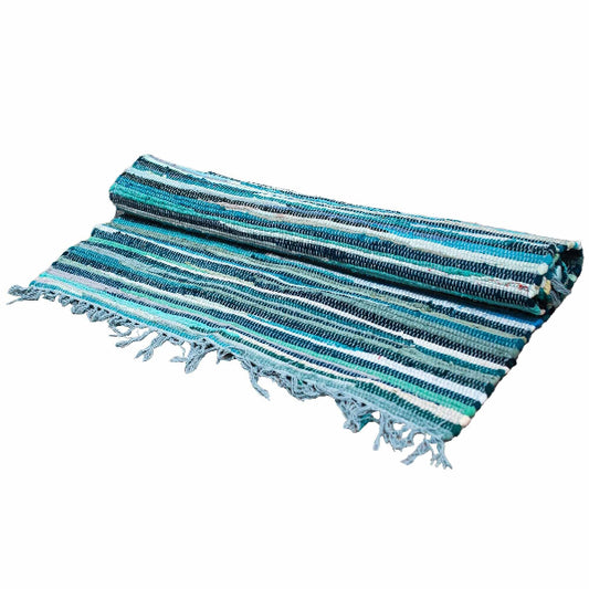 Striped blue and green towel with tassels on a white background