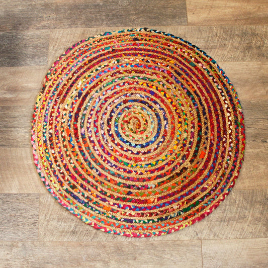 Multicolored circular rug on a wooden floor