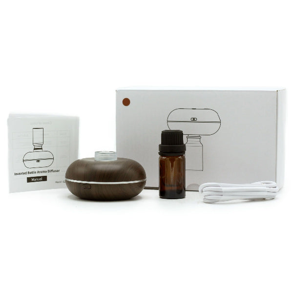 Inverted bottle aroma diffuser set with essential oil bottle and packaging on a white background