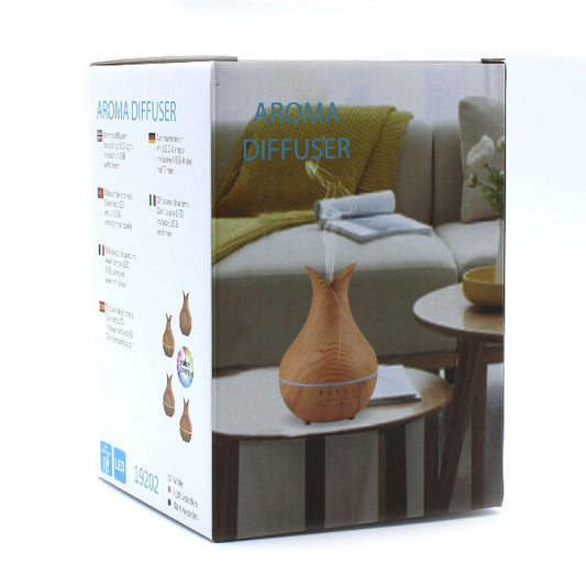Aroma diffuser packaging with wooden diffuser on a table in a living room setting