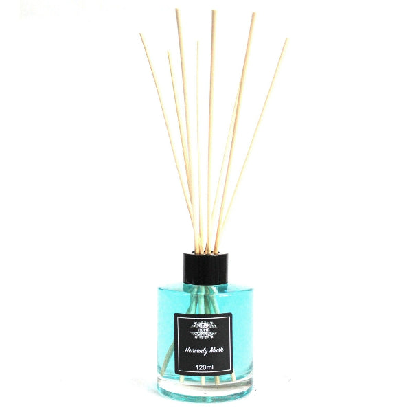Reed diffuser with wooden sticks in a clear bottle on a white background