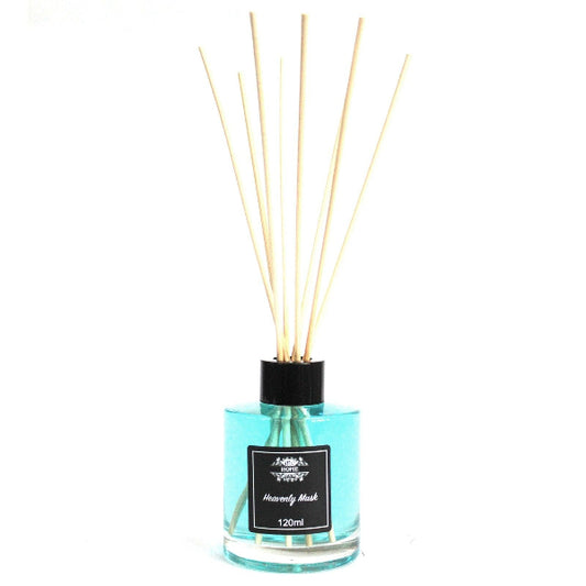 Reed diffuser with wooden sticks in a clear bottle on a white background