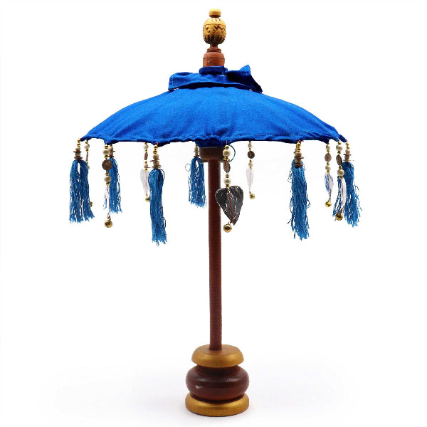 Decorative umbrella with blue canopy and tassels on a white background
