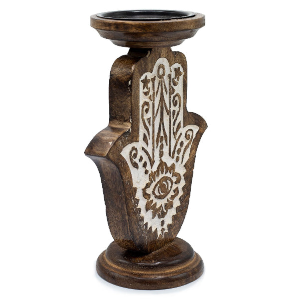 Wooden candle holder with Hamsa hand design on a white background