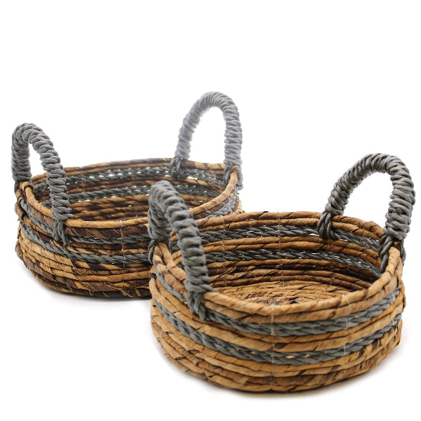 Two woven baskets with gray handles on a white background