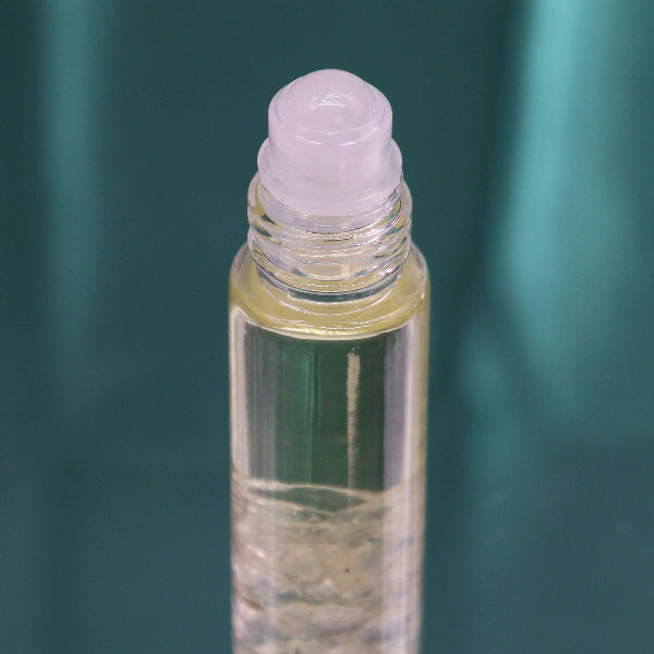 Roll-on bottle with a purple roller ball on a green background