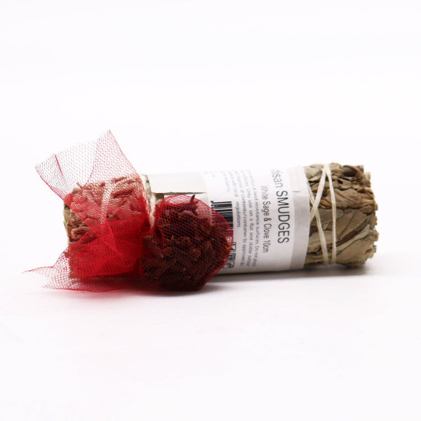 Sage smudge stick with red tulle on a white background